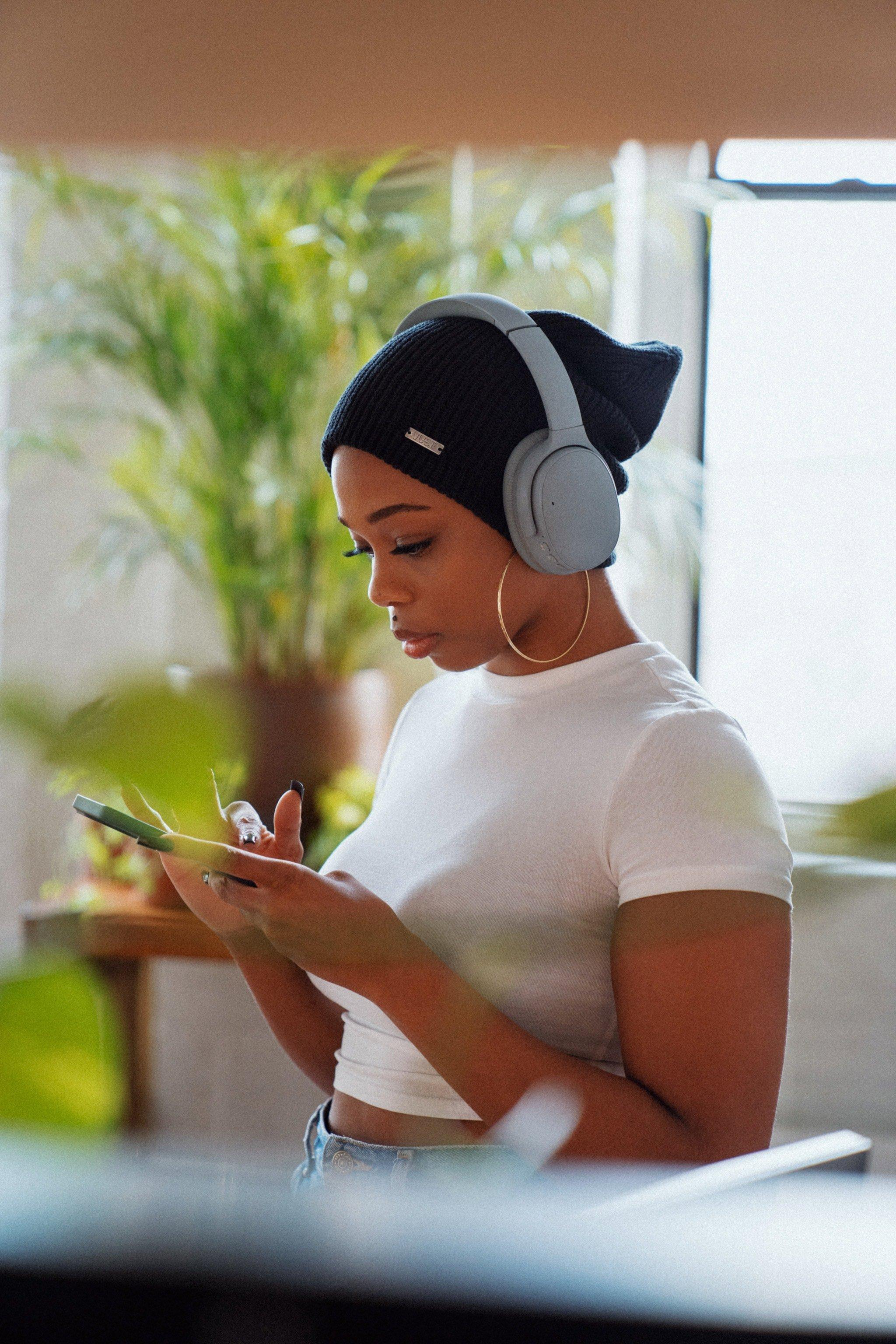 a woman listens to music with headphones