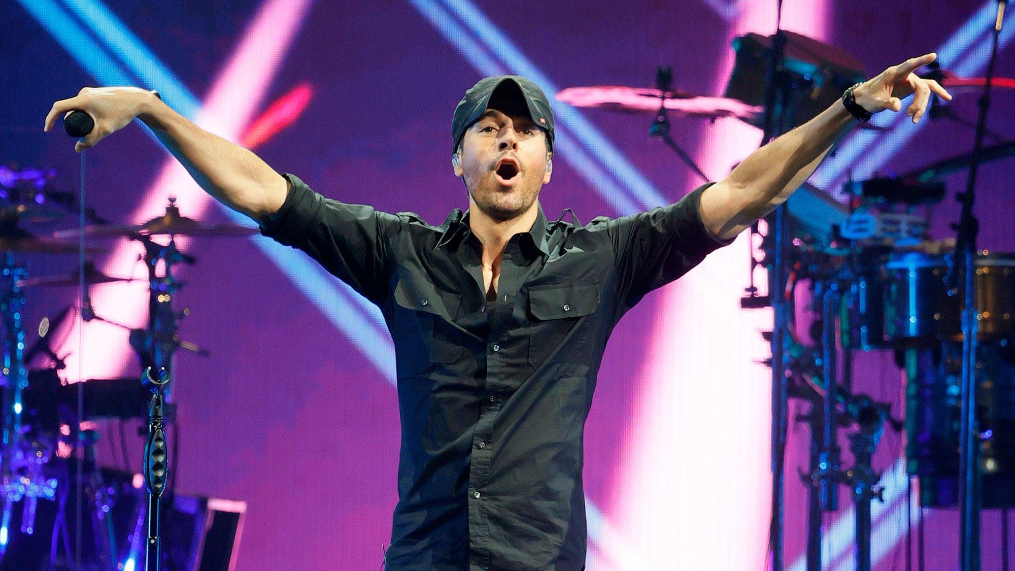 Enrique Iglesias stands with his arms out on stage during the opening night of the Enrique Iglesias and Ricky Martin Live in Concert tour at MGM Grand Garden Arena on September 25, 2021 in Las Vegas, Nevada.