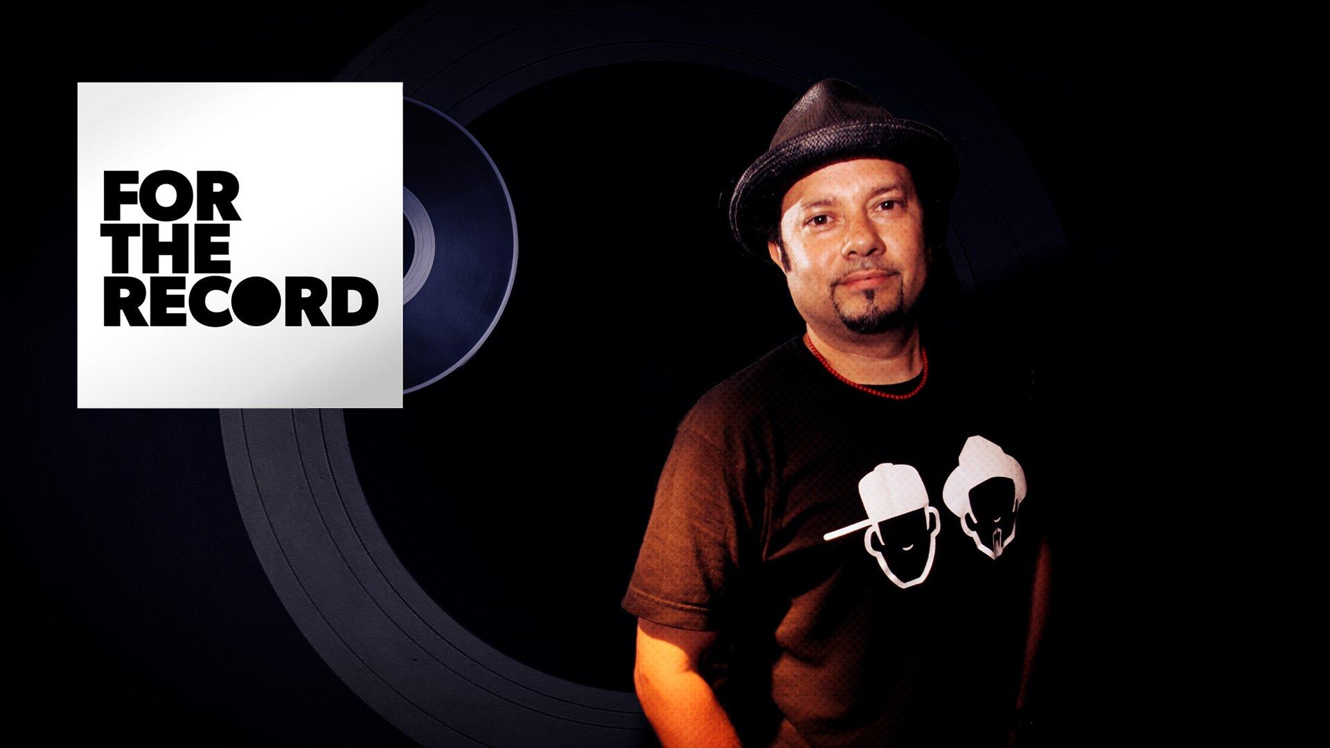 "Little" Louie Vega smiles at the camera while wearing his merchandise