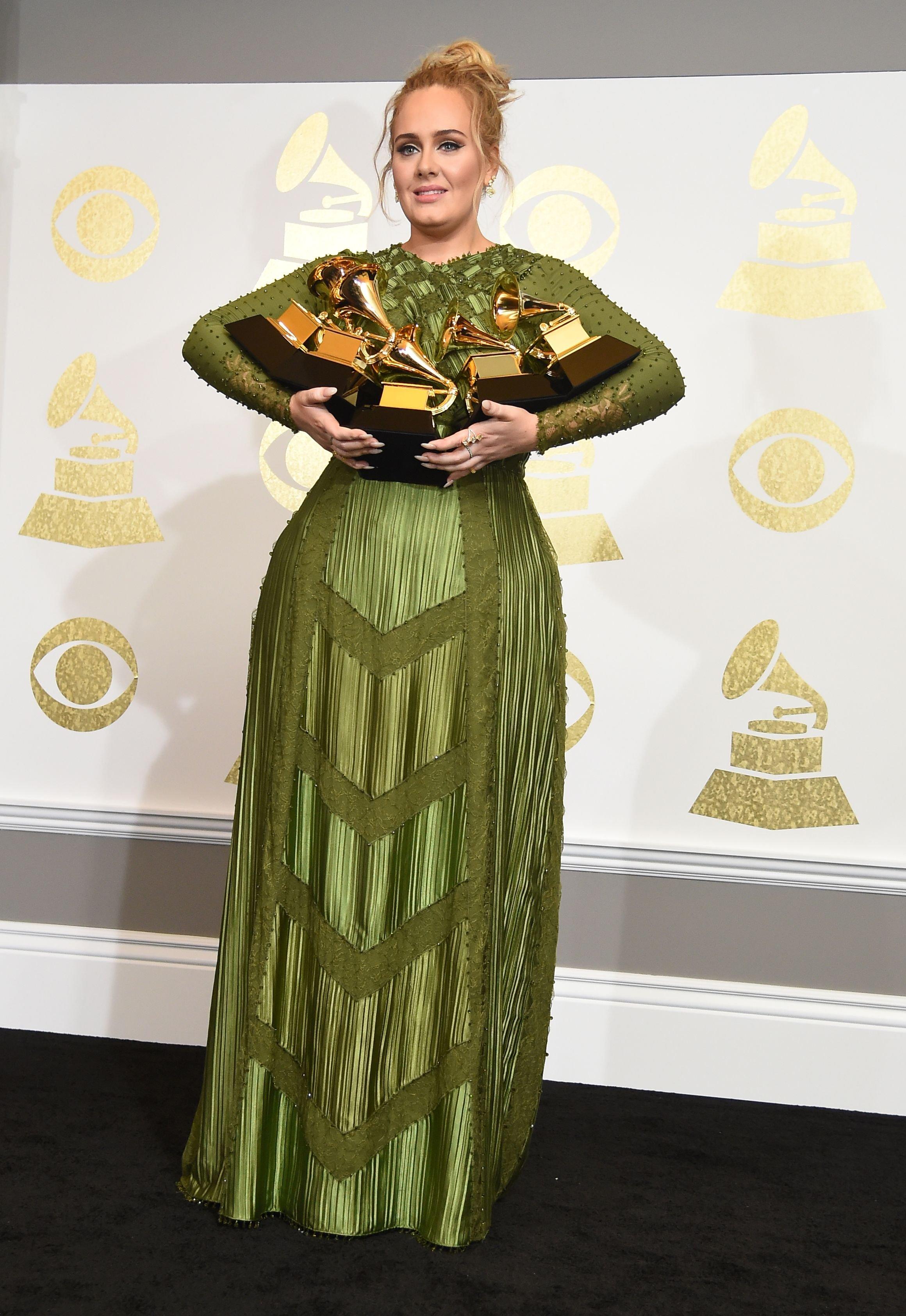 Adele holding GRAMMY Awards