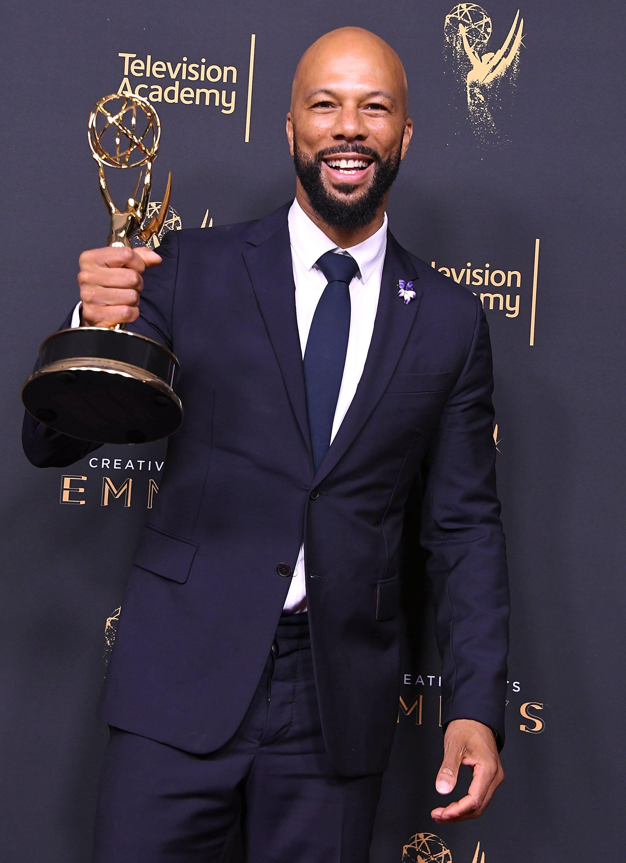 Common holding Emmy award