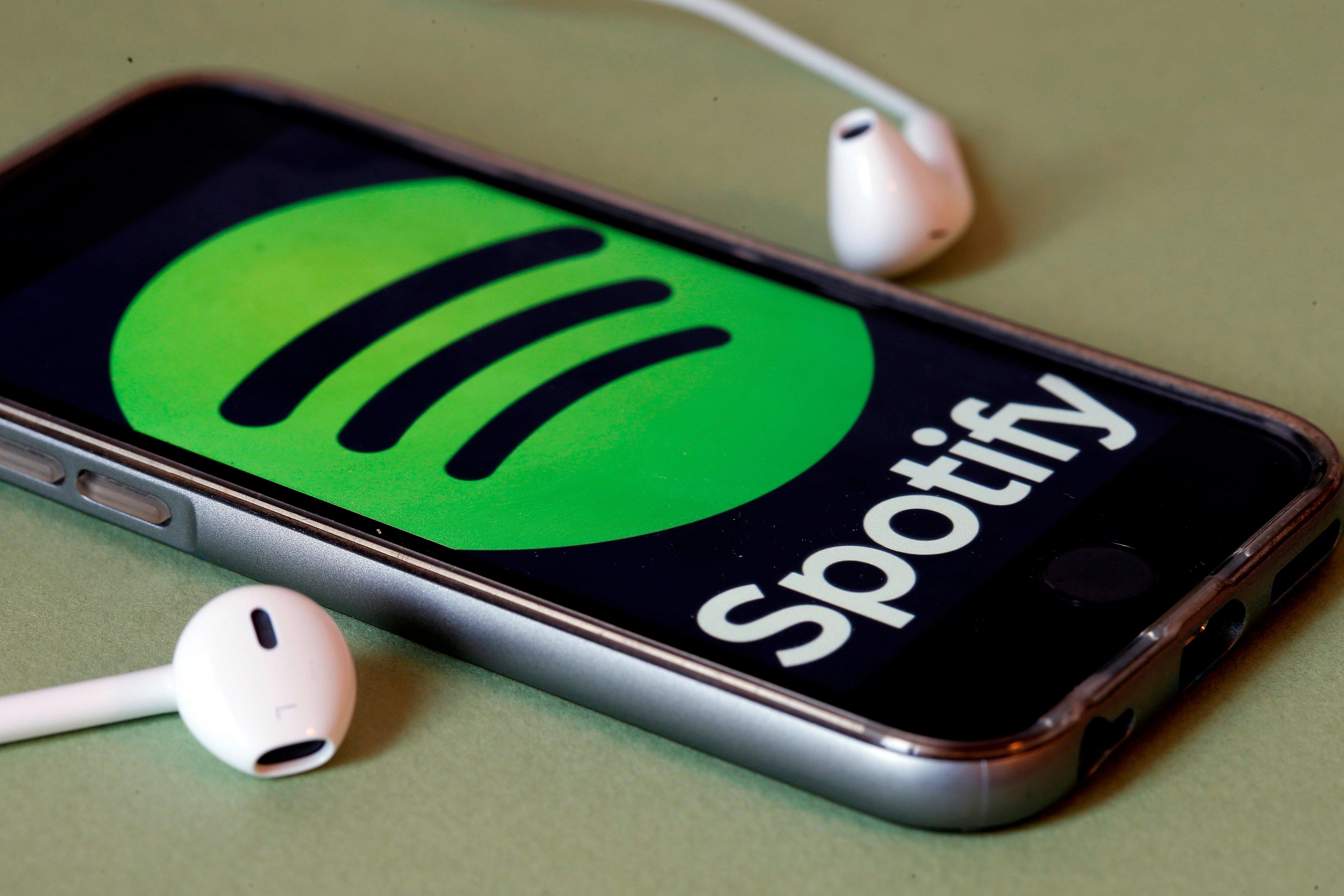 Spotify logo on phone with headphones