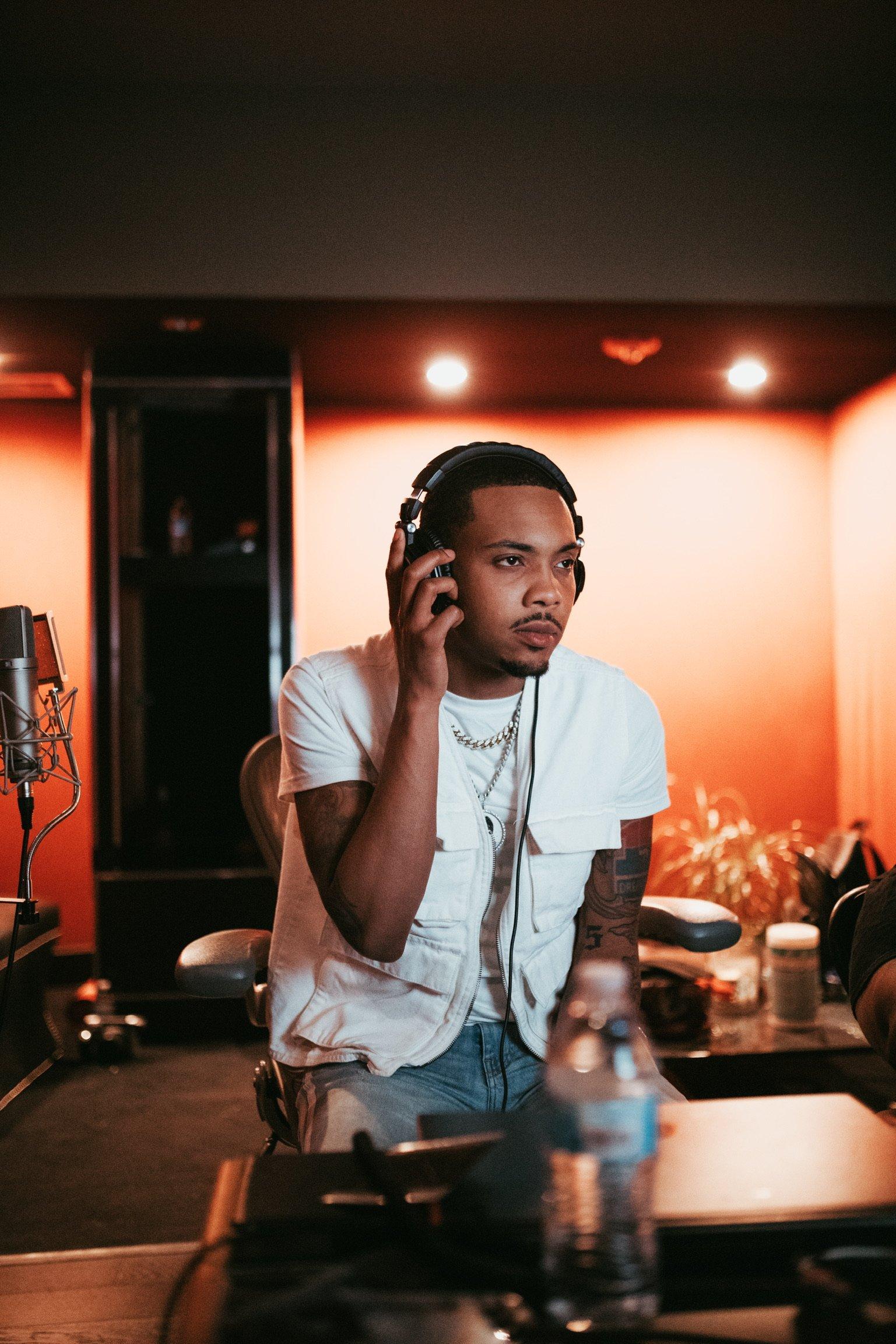 rapper G Herbo wears headphones in the studio