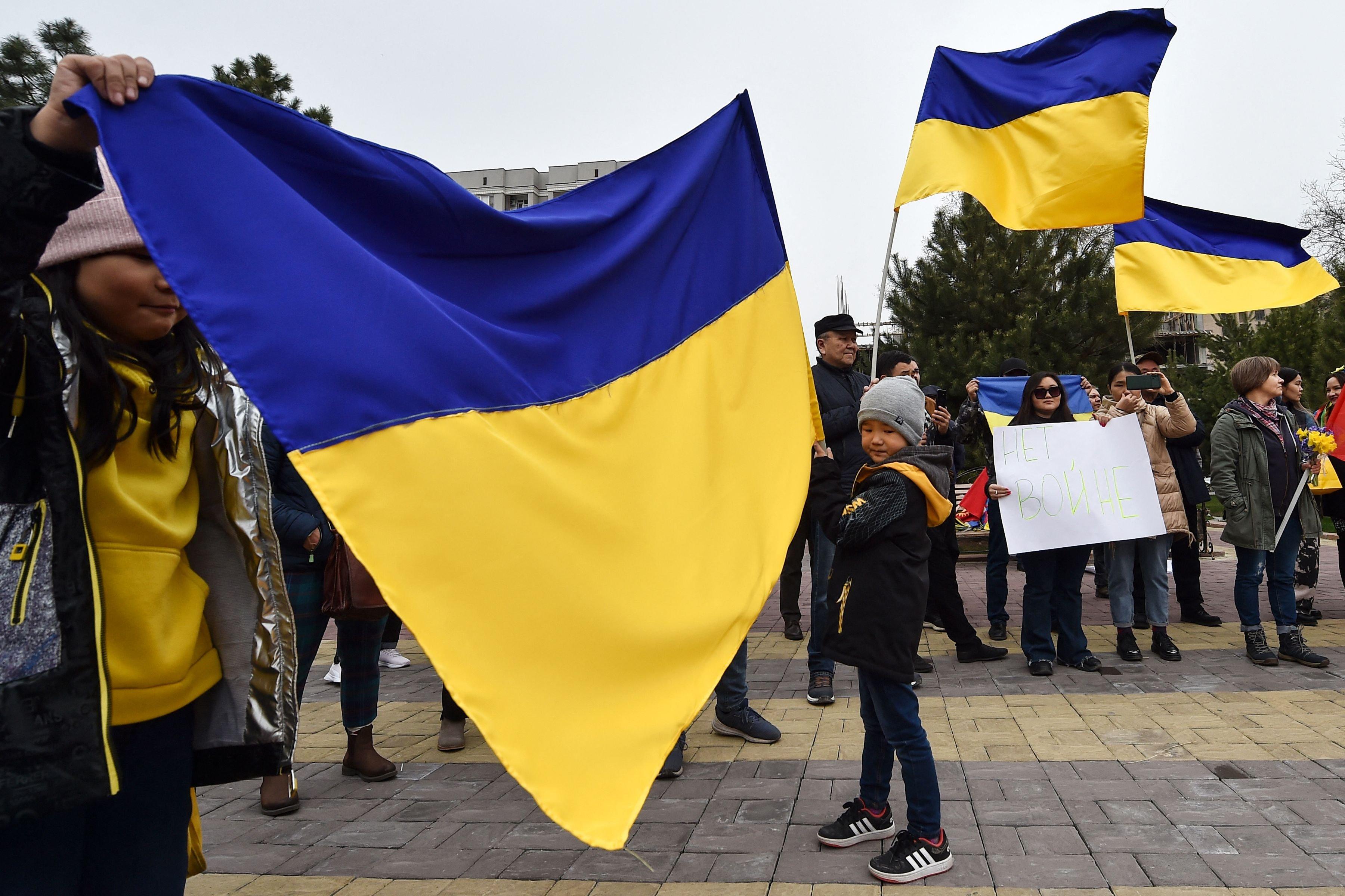 Demonstrators attend a rally against ongoing Russian military action in Ukraine in central Bishkek on March 26, 2022