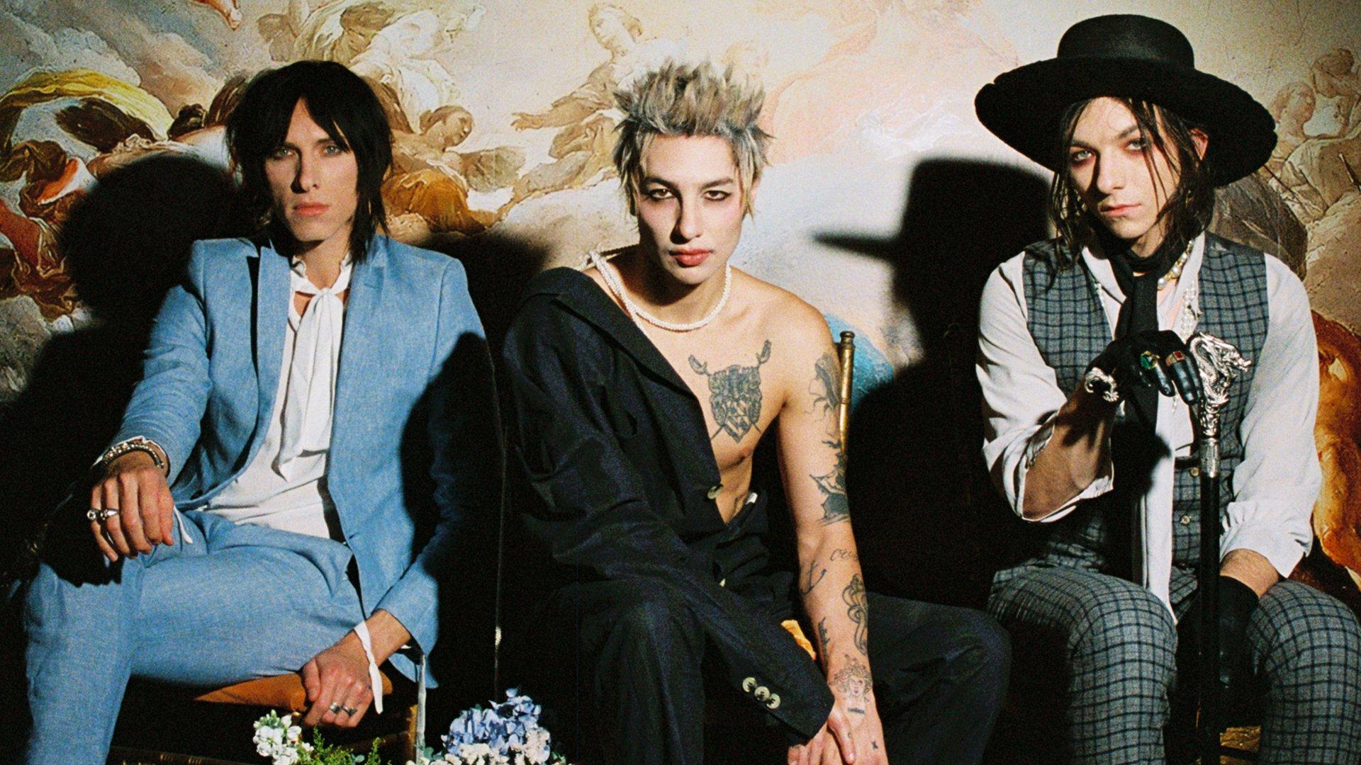 The three brothers of Palaye Royale pose together, seated