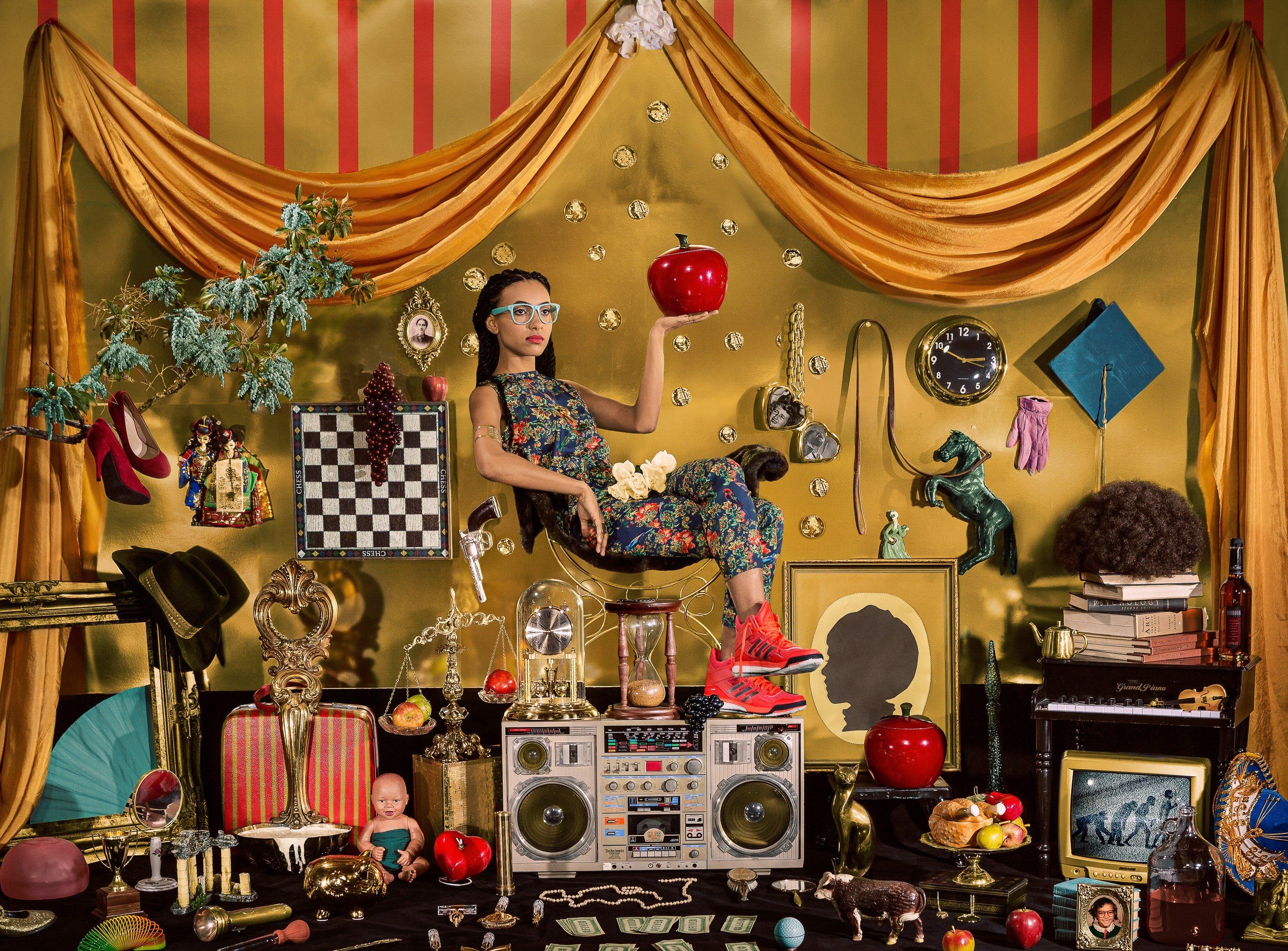 Esperanza Spalding sits atop a boombox in an elaborately decorated scene by photographer Holly Andres