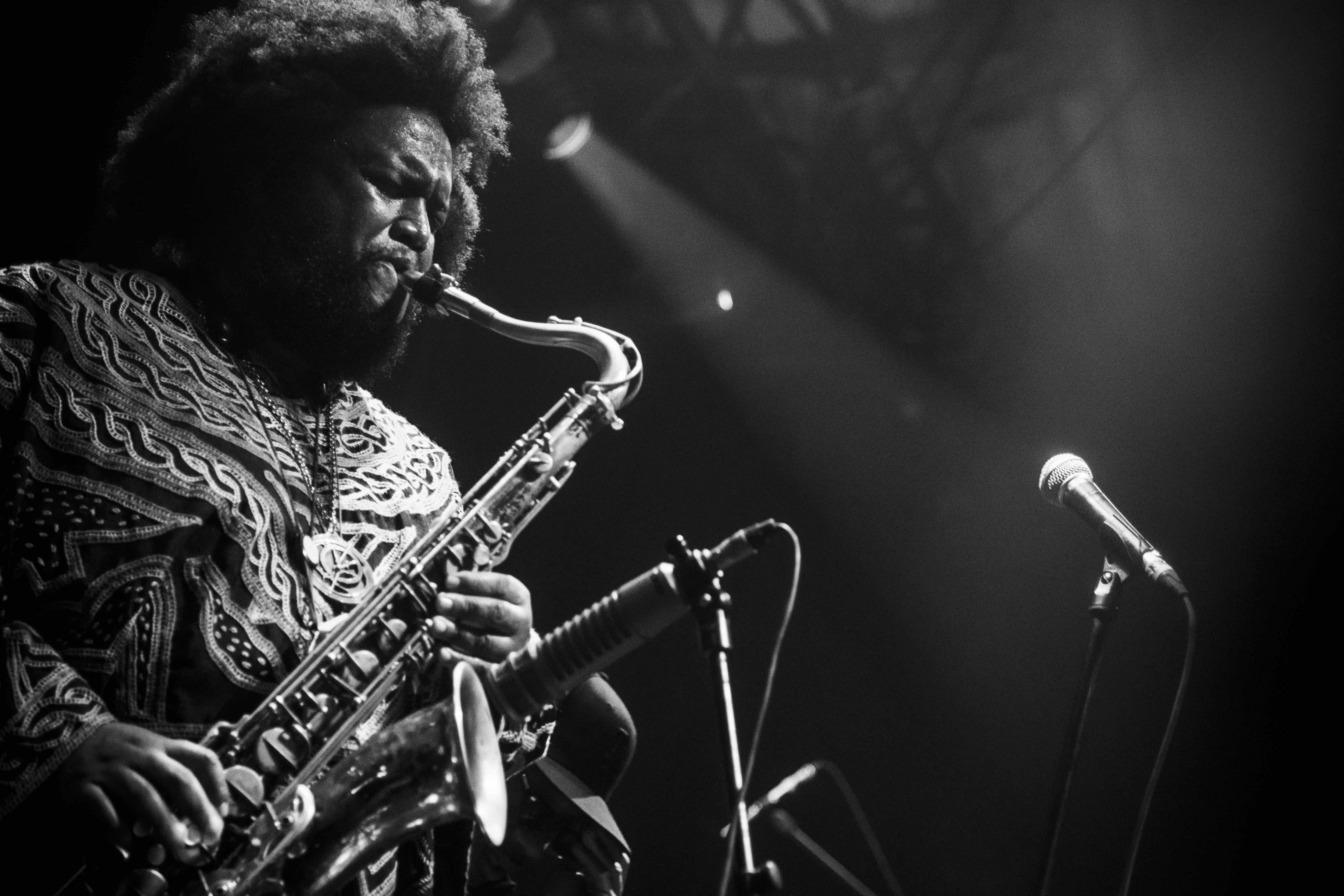 black and white image of Kamasi Washington playing saxophone in Rio de Janeiro, Brazil in 2019