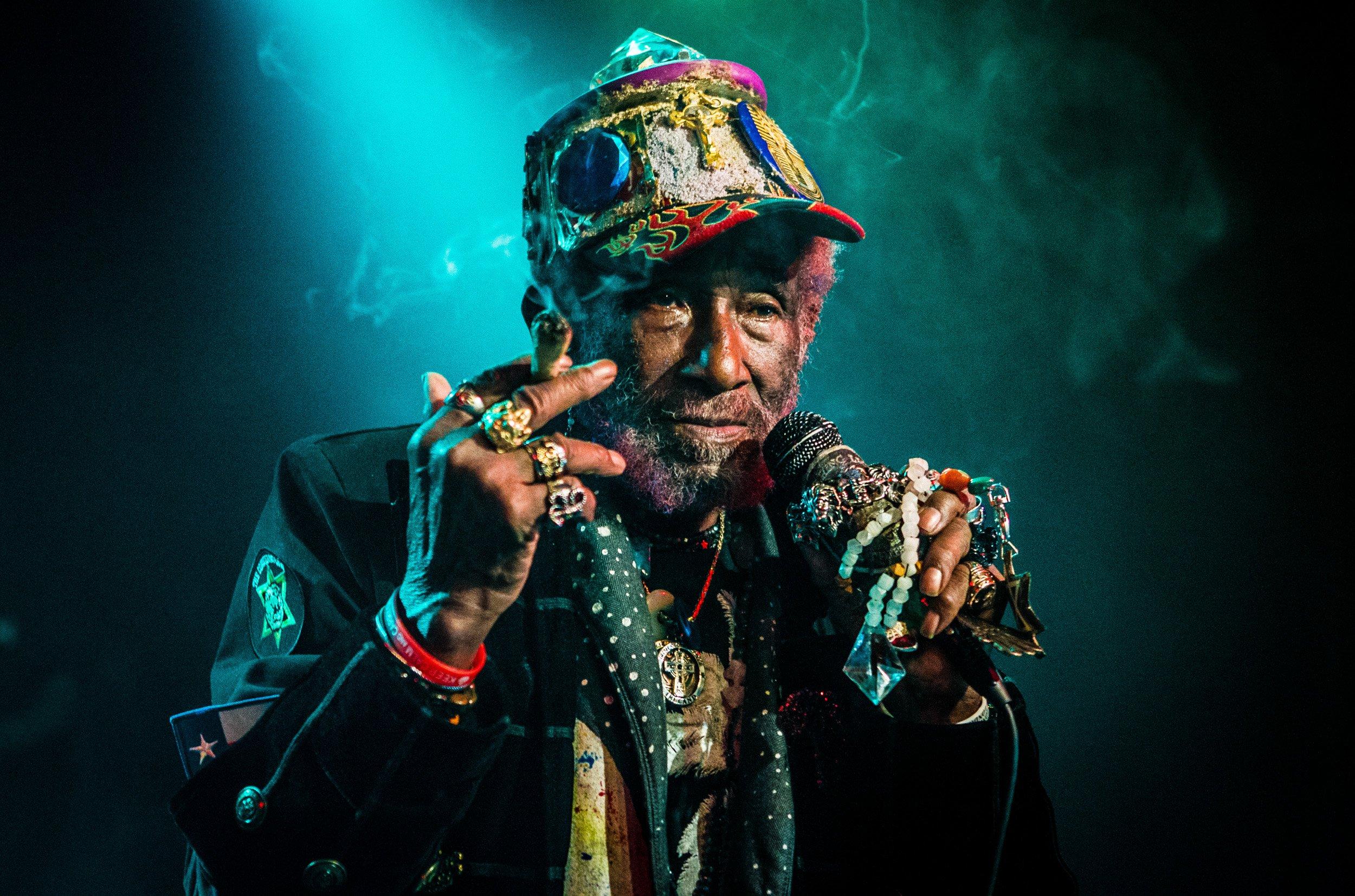Lee "Scratch" Perry wears a colorful hat and many rings while on the mic