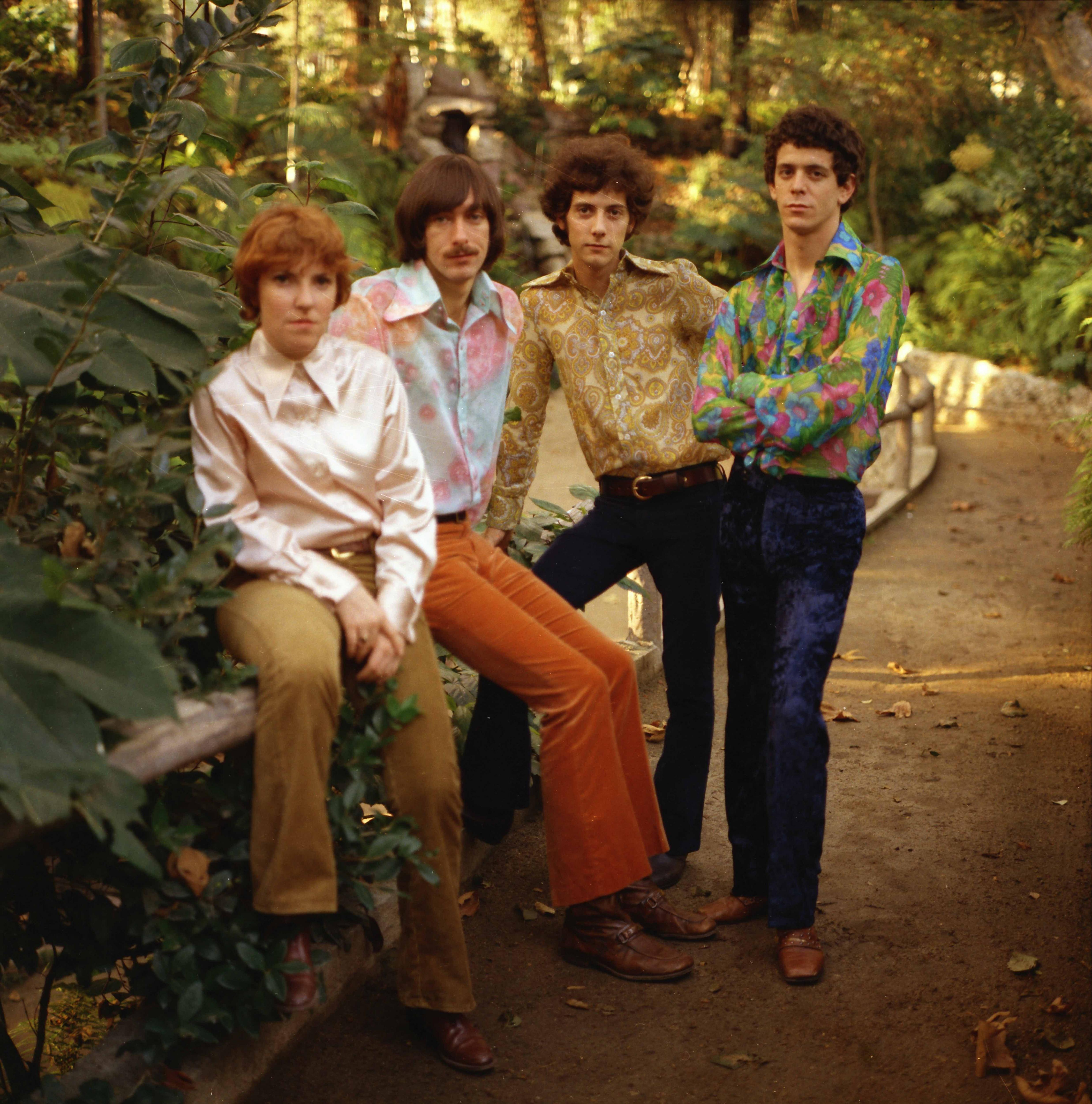 The Velvet Underground pose in a forest in colorful shirts