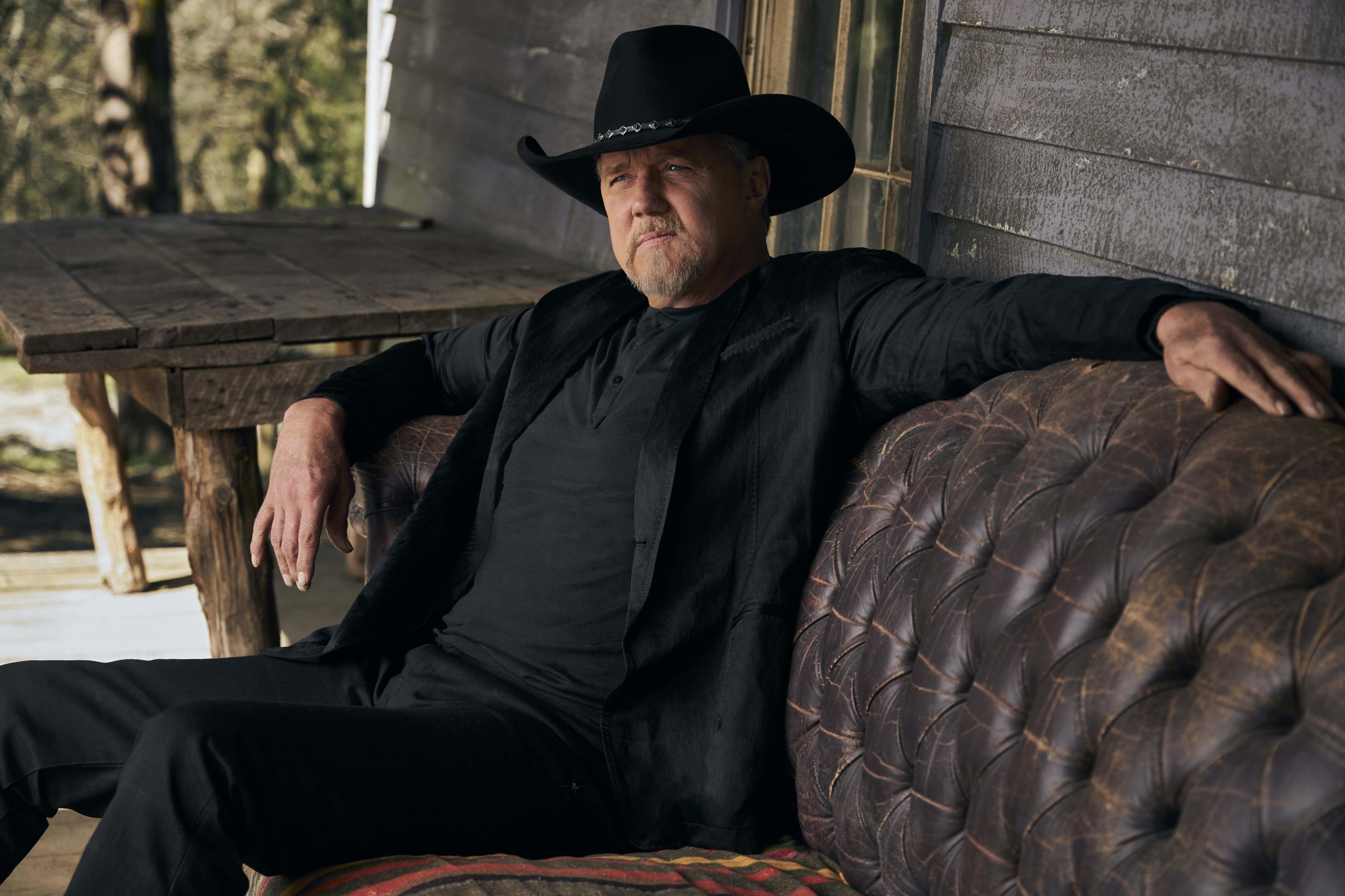 Trace Adkins poses on a leather couch in all-black