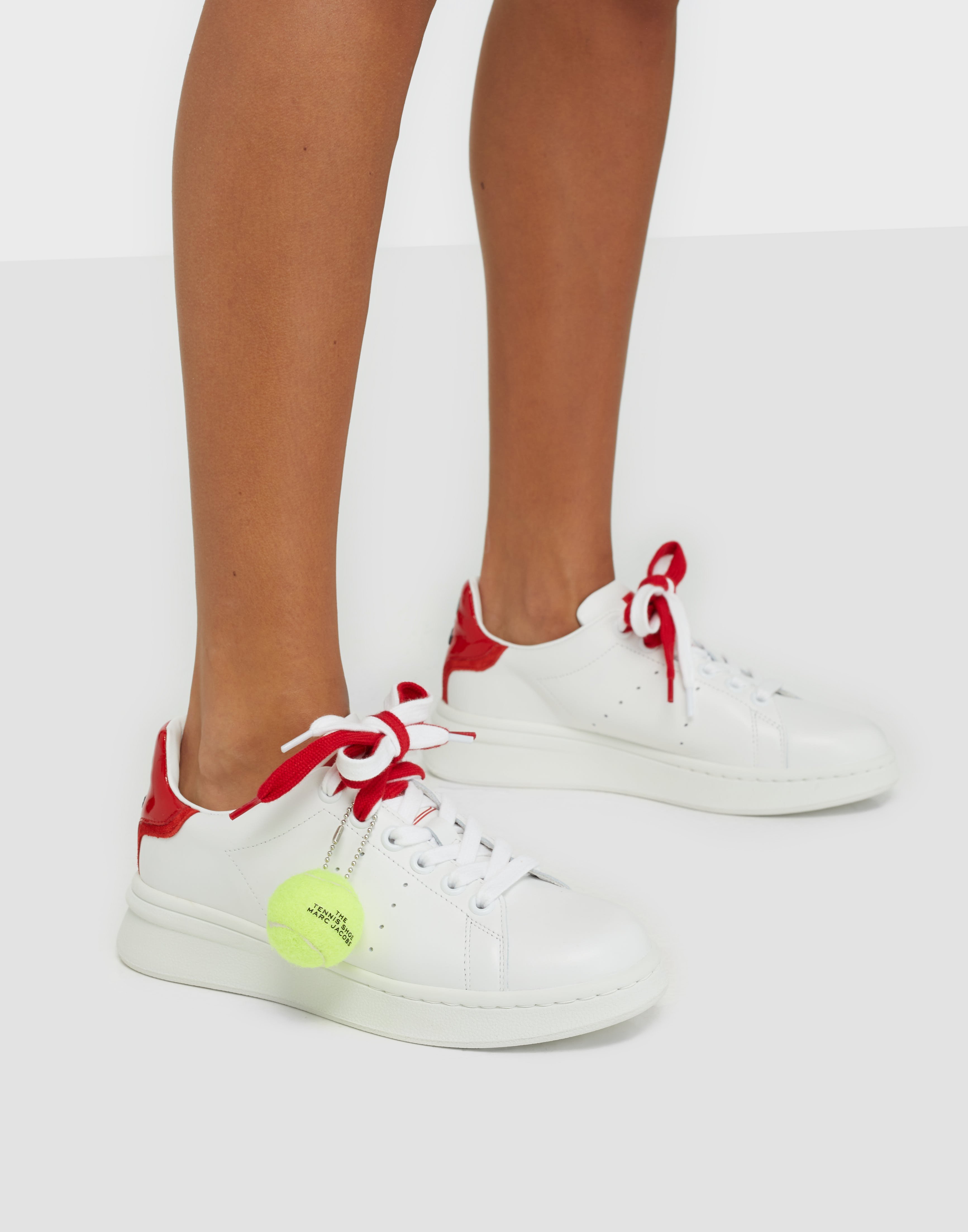 white and red tennis shoes