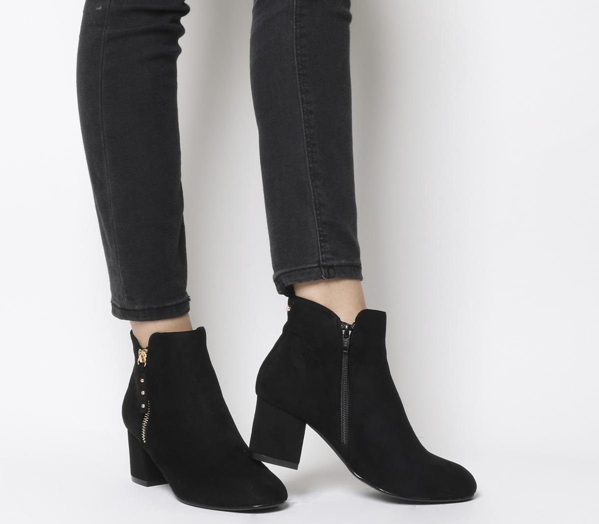 black boots with gold zip