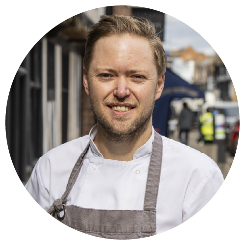 Jon Coates, Head Chef at The Woodsman (The Great Game Guide) Logo