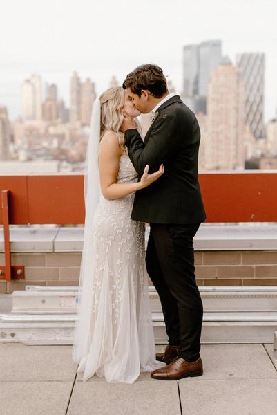 Rachel and Robbie wedding portraits in front of New York city skyline. Rachel in Vowd radiant dress