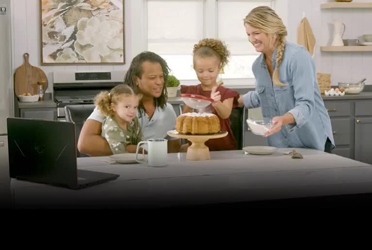 Family gathered around a table with a cake